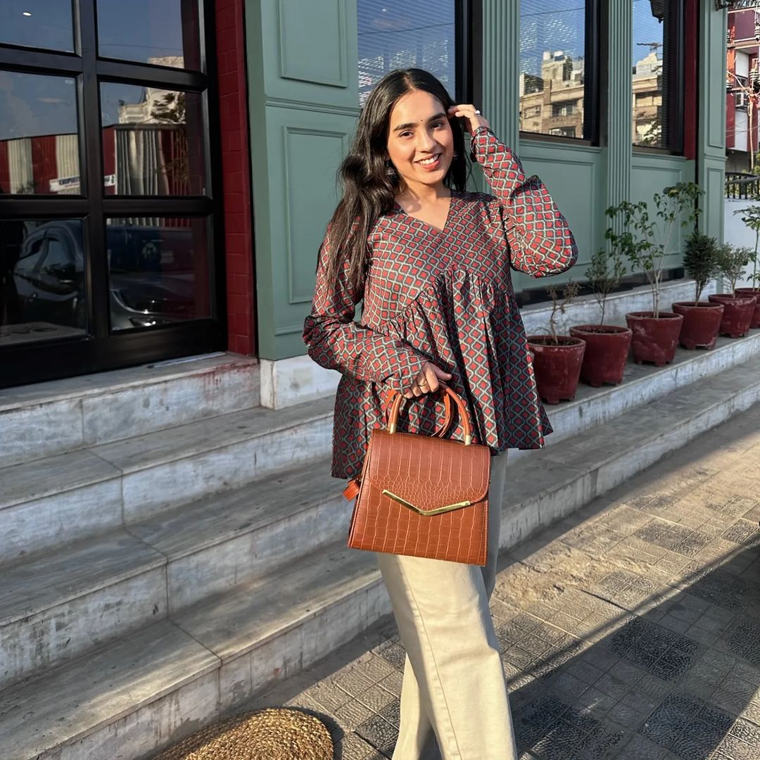 A woman wearing a floral cotton top