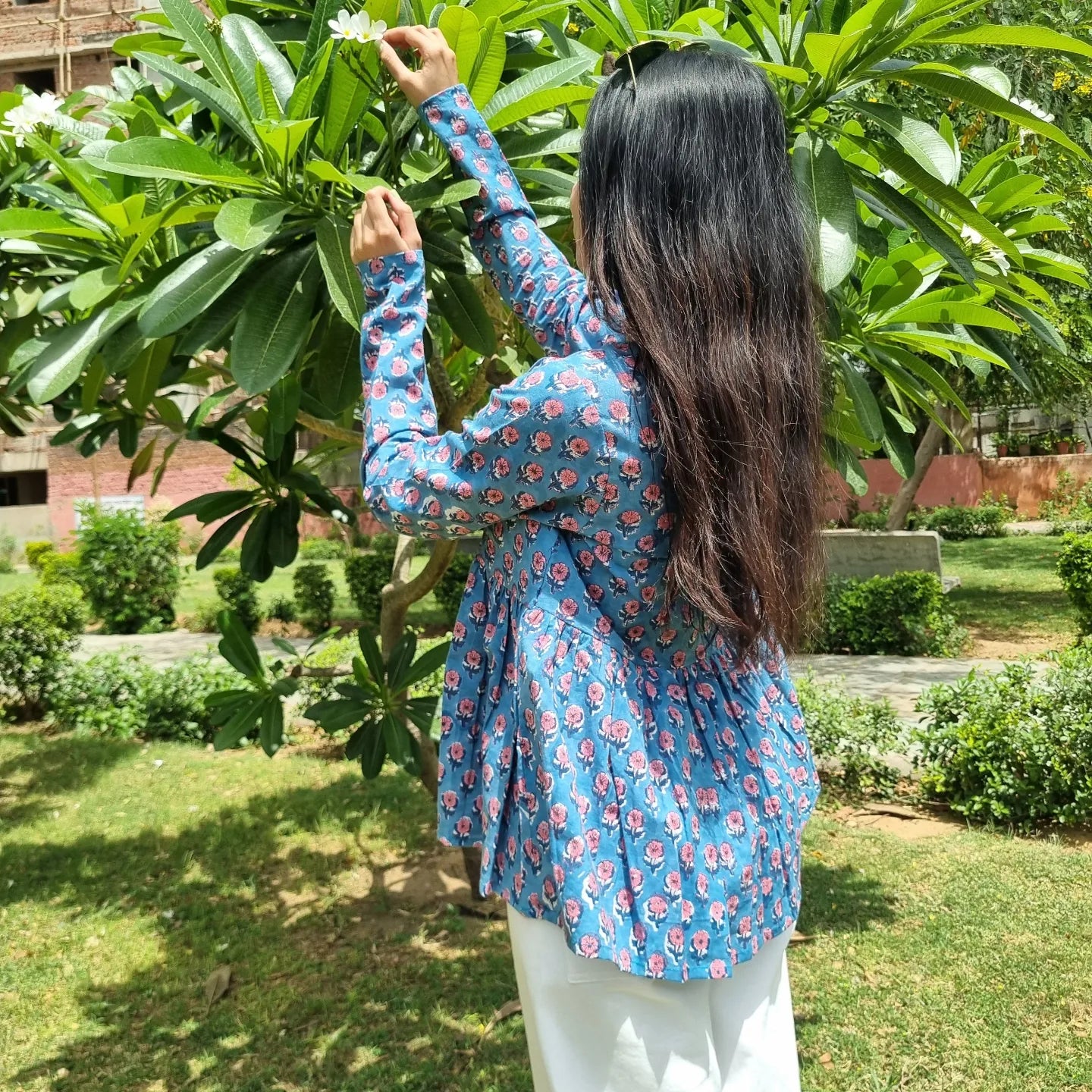 A woman wearing a blue floral cotton kurti