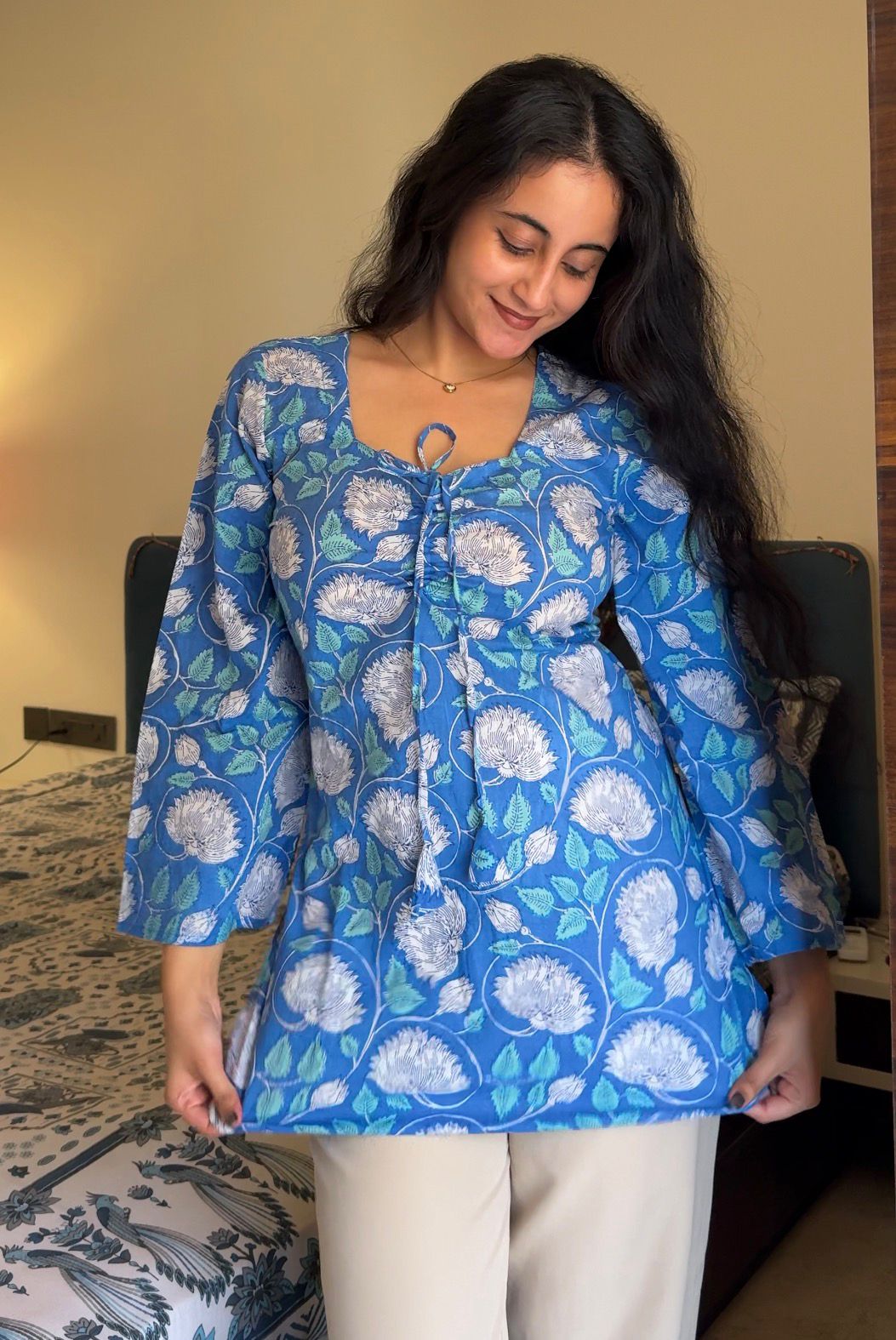 A woman wearing a blue floral cotton kurti