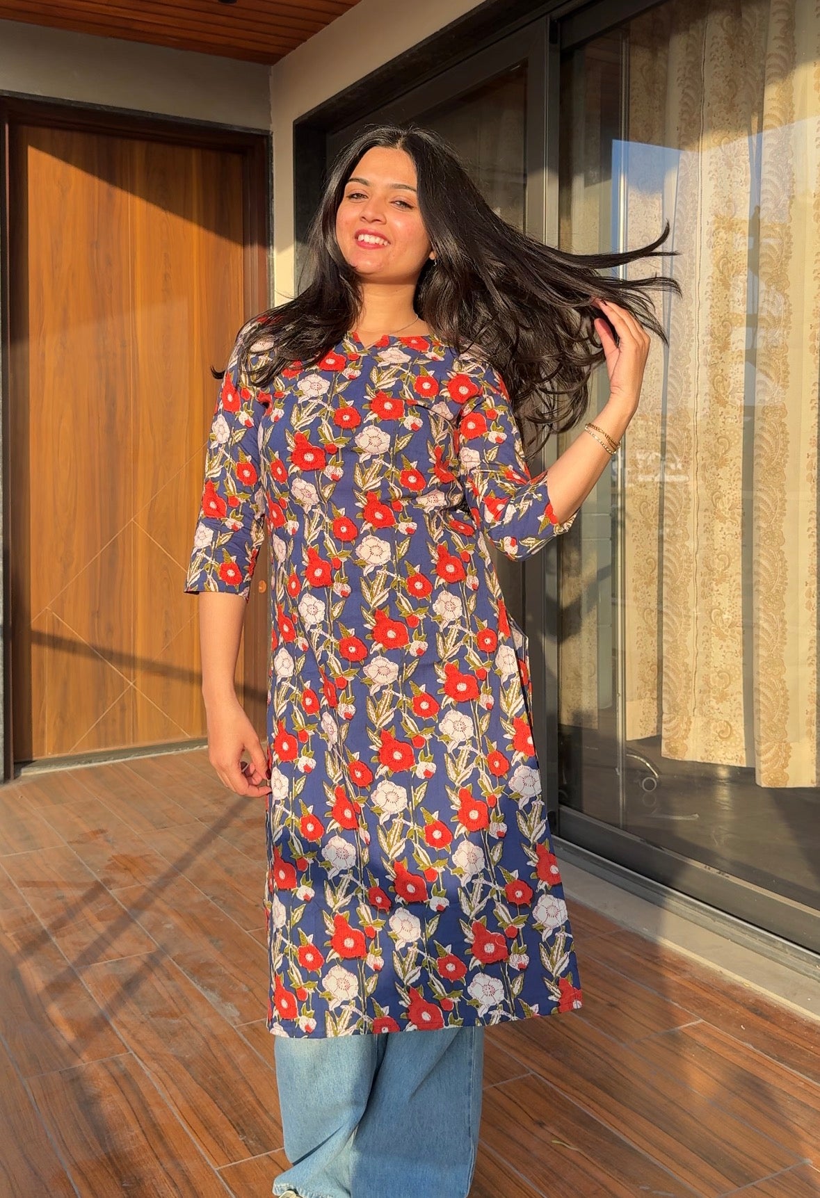 A woman wearing a floral cotton kurti