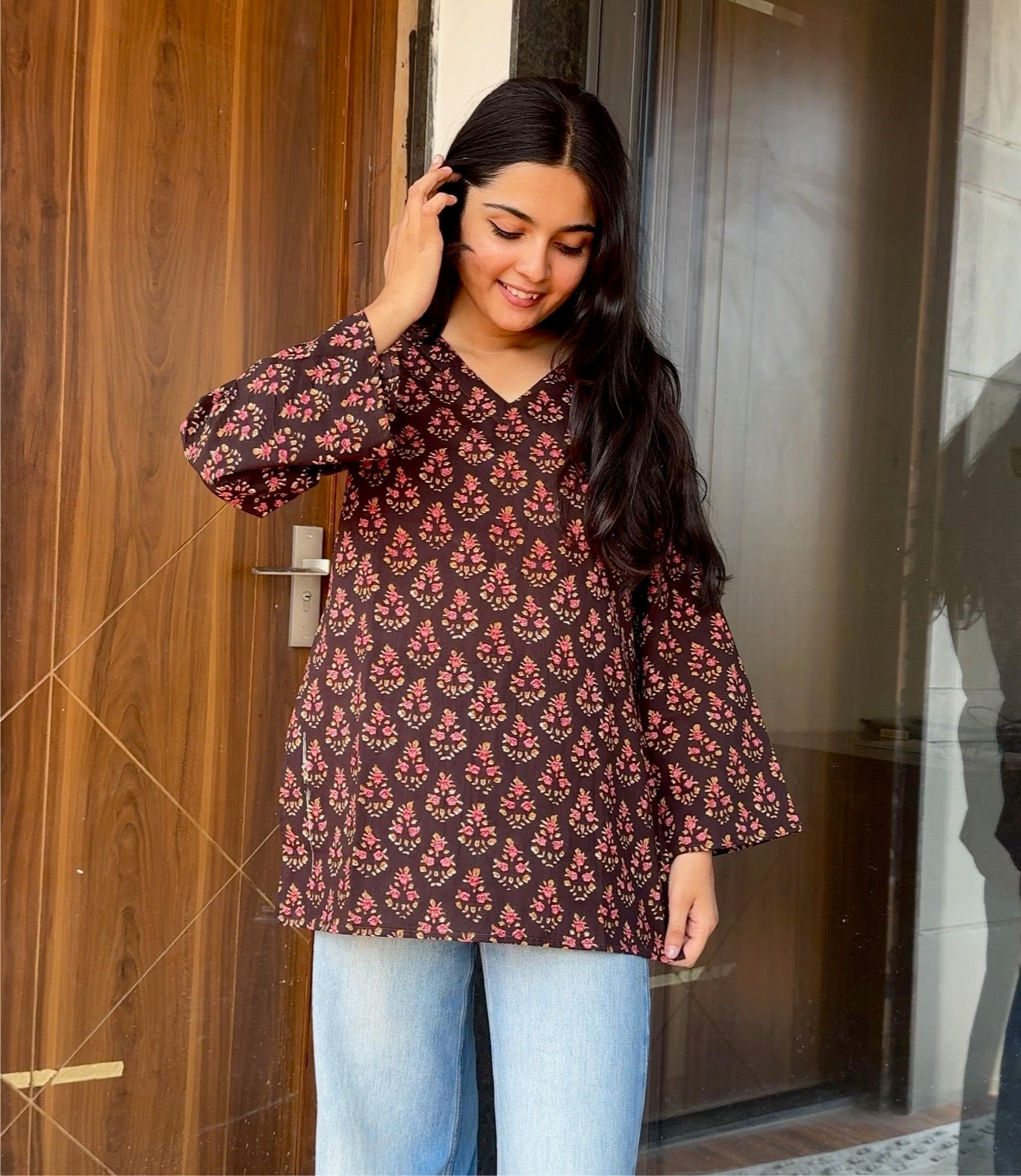 A woman wearing a blue floral cotton kurti
