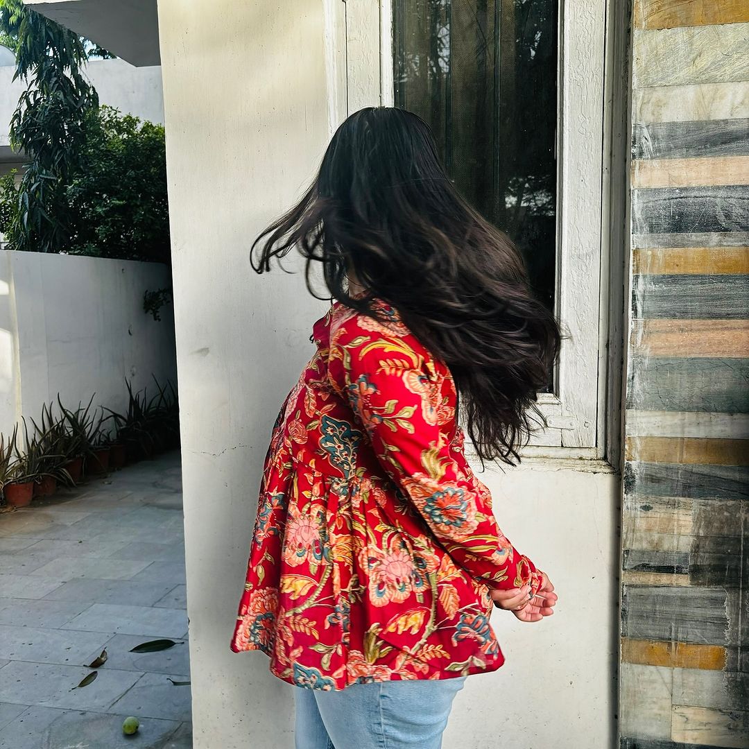  A woman wearing a  floral cotton peplum top