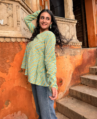  A woman wearing a blue floral cotton peplum top