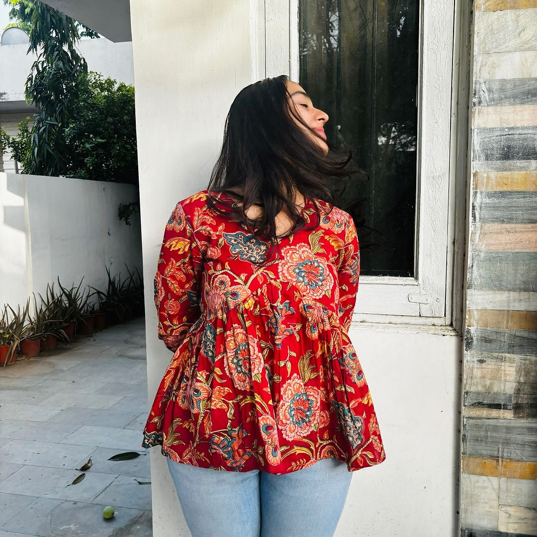  A woman wearing a  floral cotton peplum top