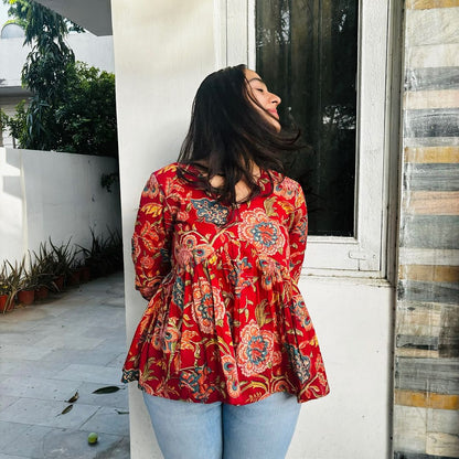  A woman wearing a  floral cotton peplum top