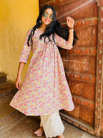 A woman wearing a pink floral cotton kurti