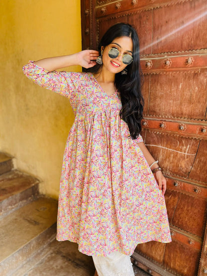 A woman wearing a pink floral cotton kurti