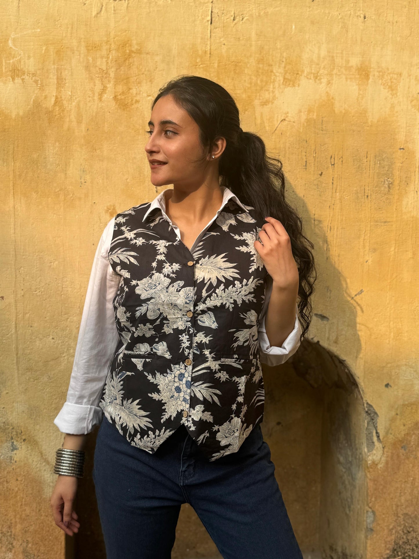 A woman wearing a black floral cotton vest top
