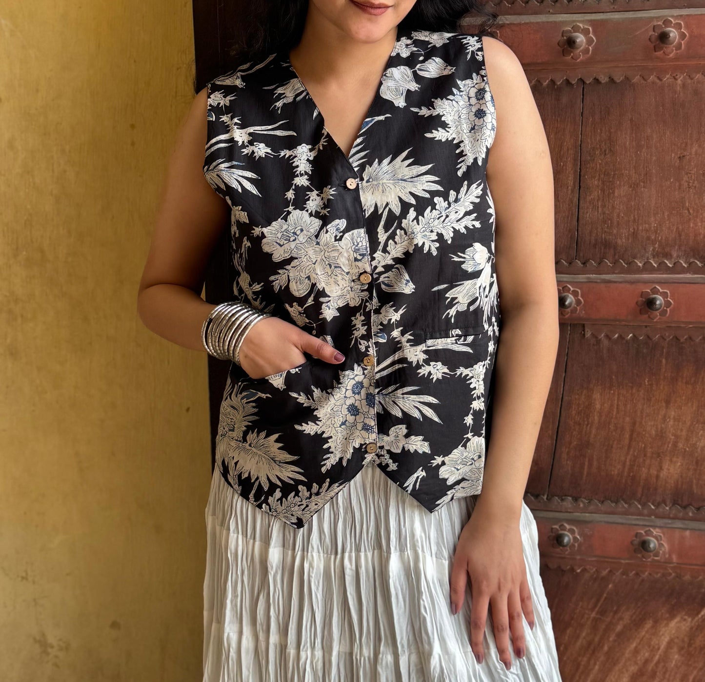 A woman wearing a black  floral cotton vest top
