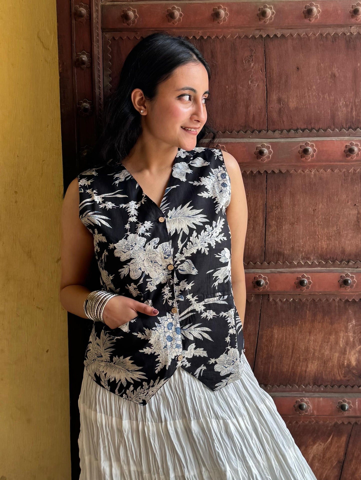 A woman wearing a black floral cotton vest top