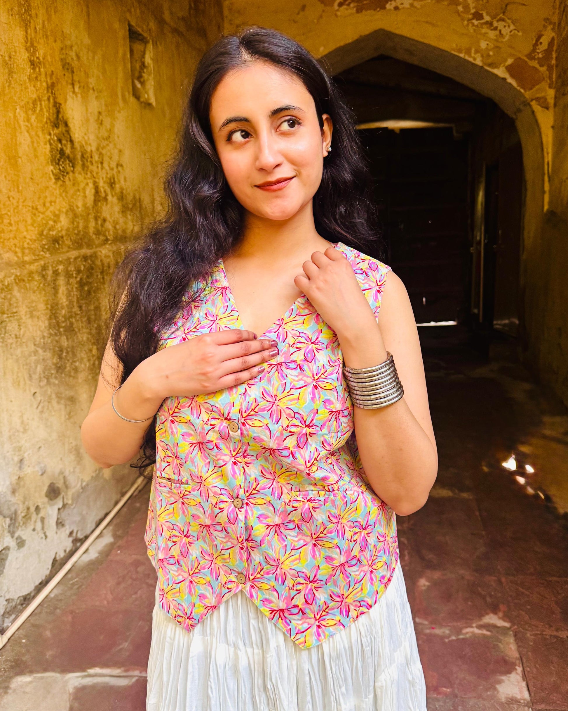 A woman wearing a pink floral cotton Vest Top