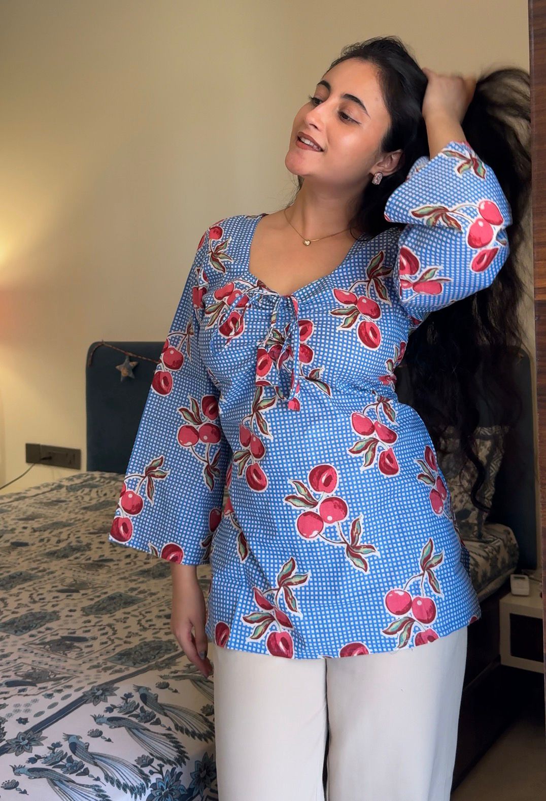 A woman wearing a blue floral cotton kurti 