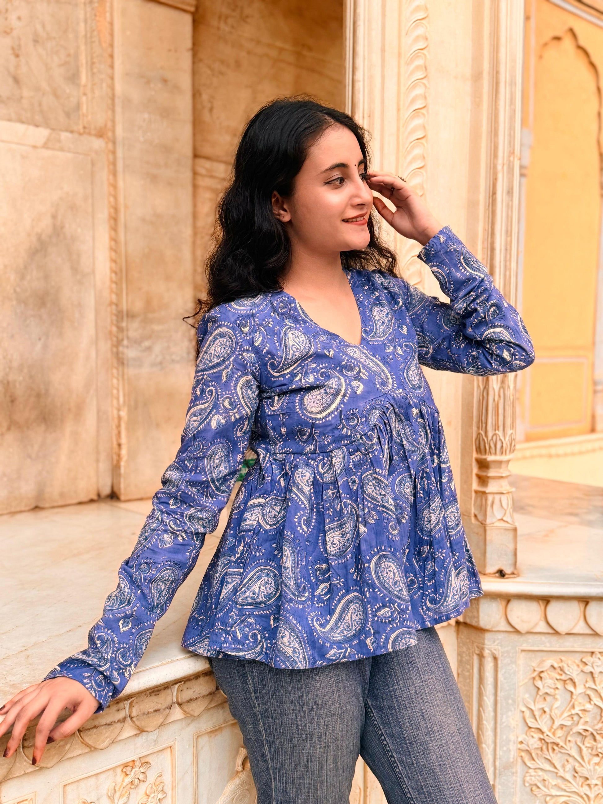 A woman wearing a blue floral cotton top