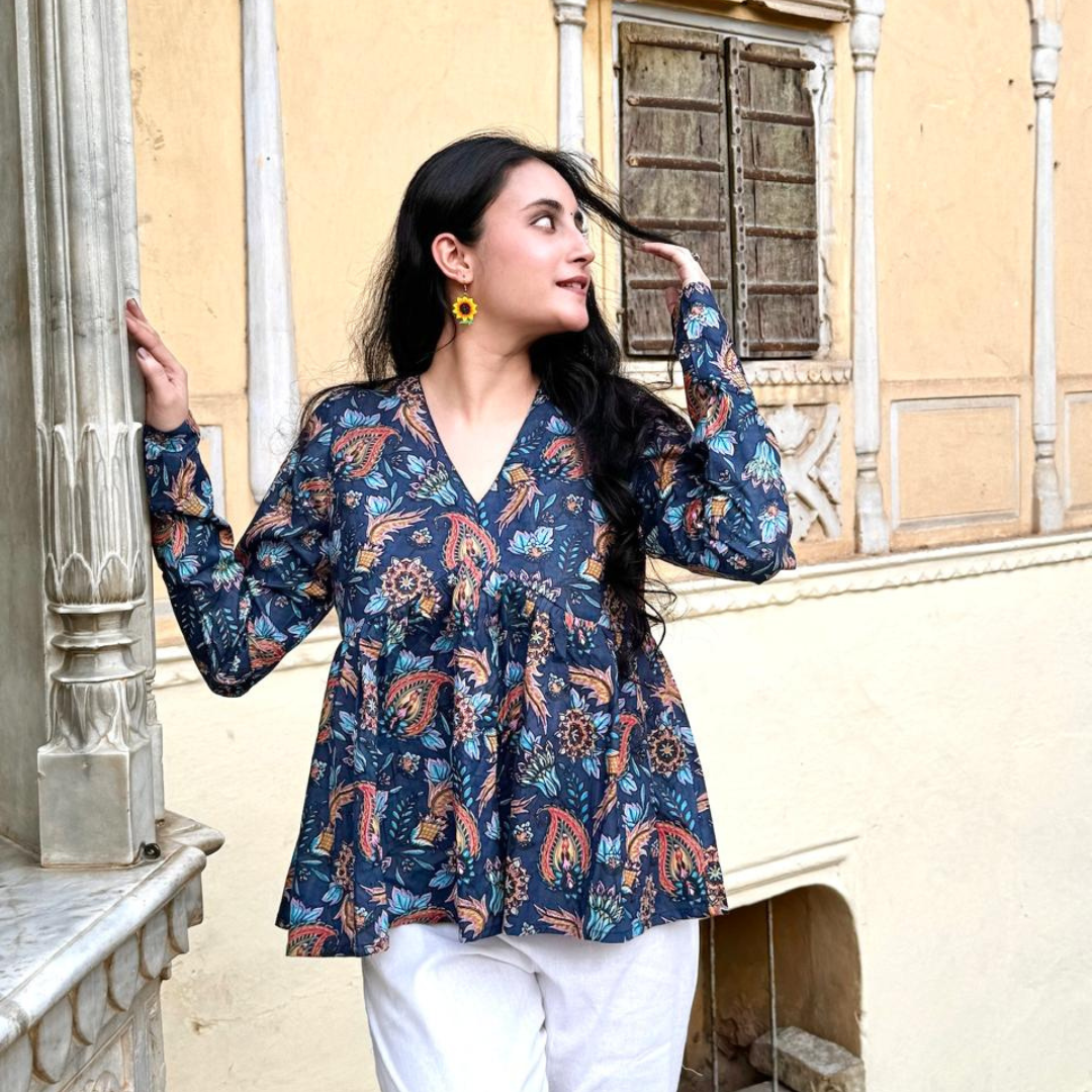 A woman wearing a blue floral cotton peplum  top