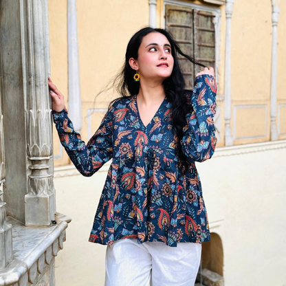 A woman wearing a blue floral cotton peplum  top