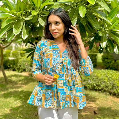 A woman wearing a green floral cotton peplum  top
