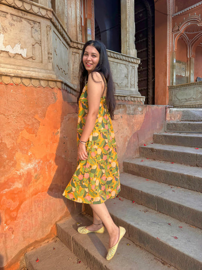 A woman wearing a yellow floral cotton  summer dress