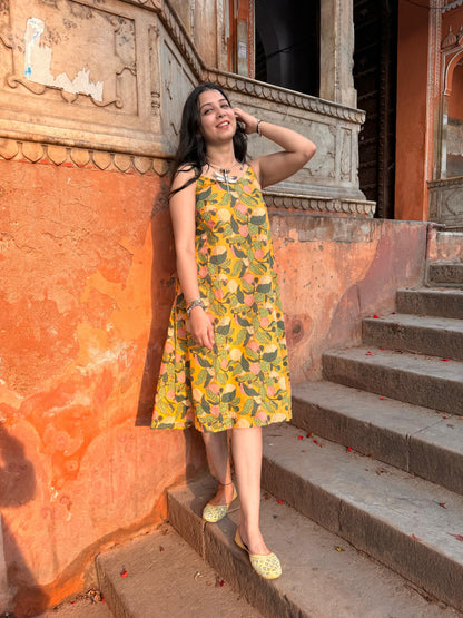 A woman wearing a yellow floral cotton  summer dress