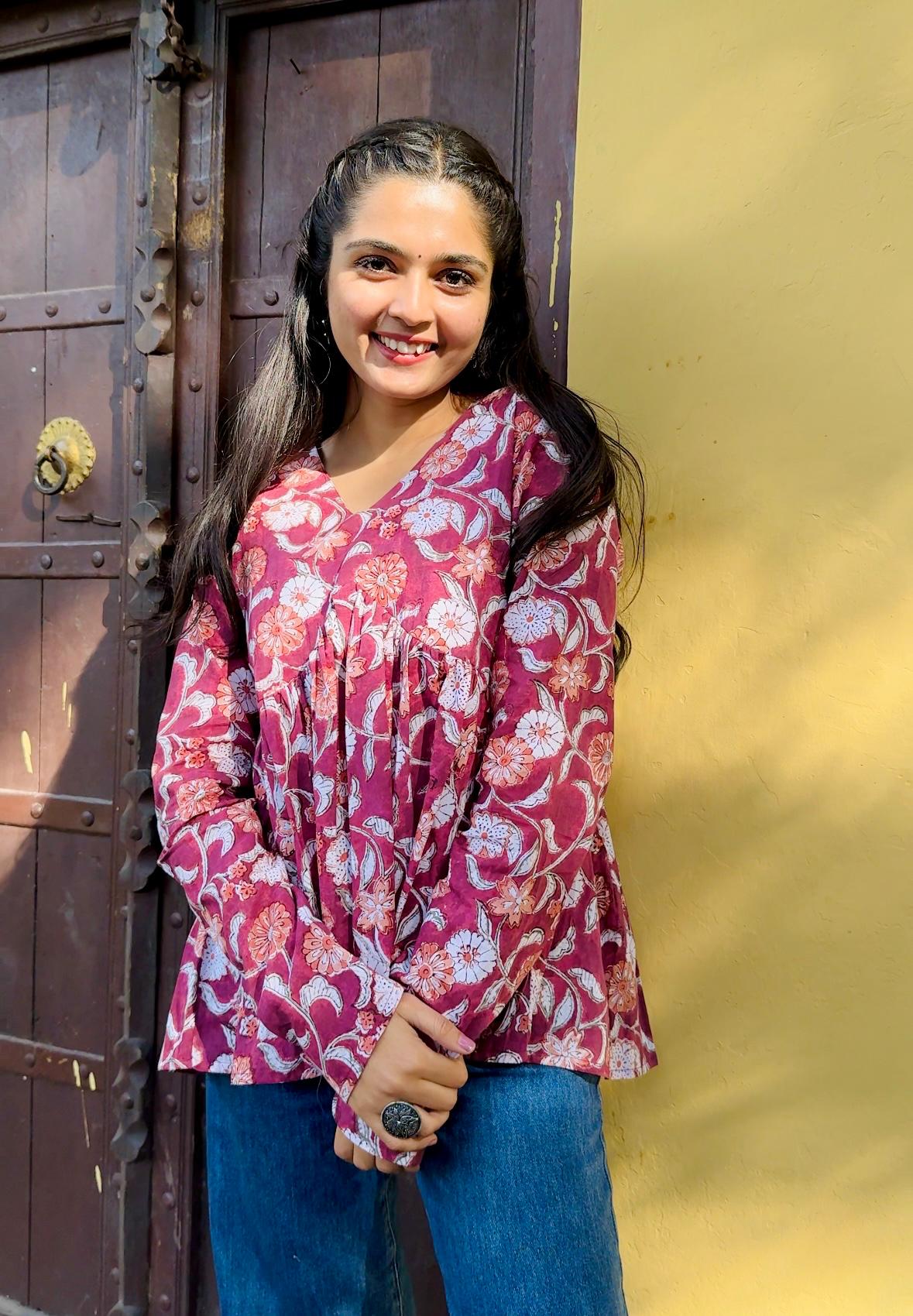  A woman wearing a blue floral cotton top