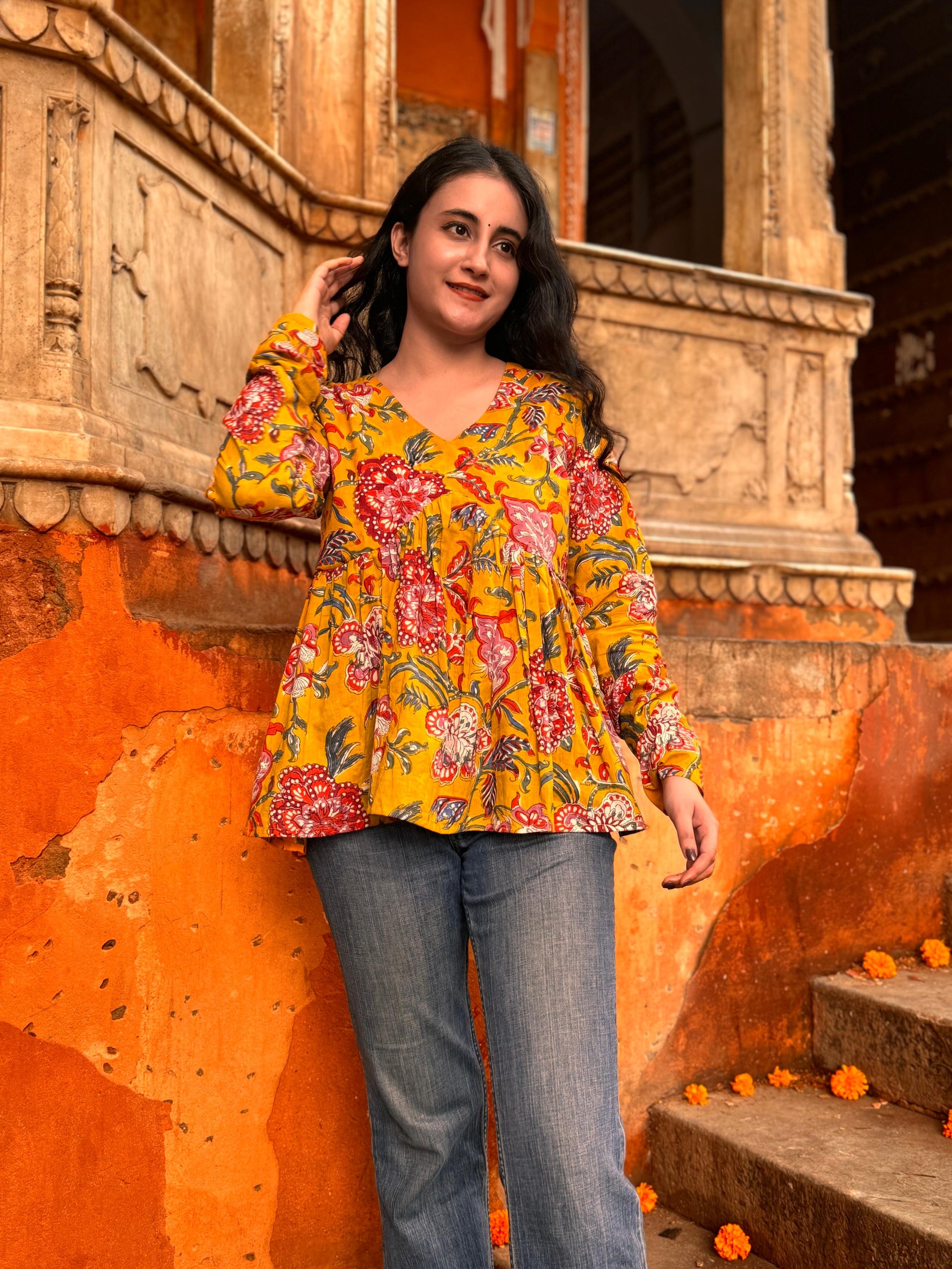 A woman wearing a Yellow floral cotton top
