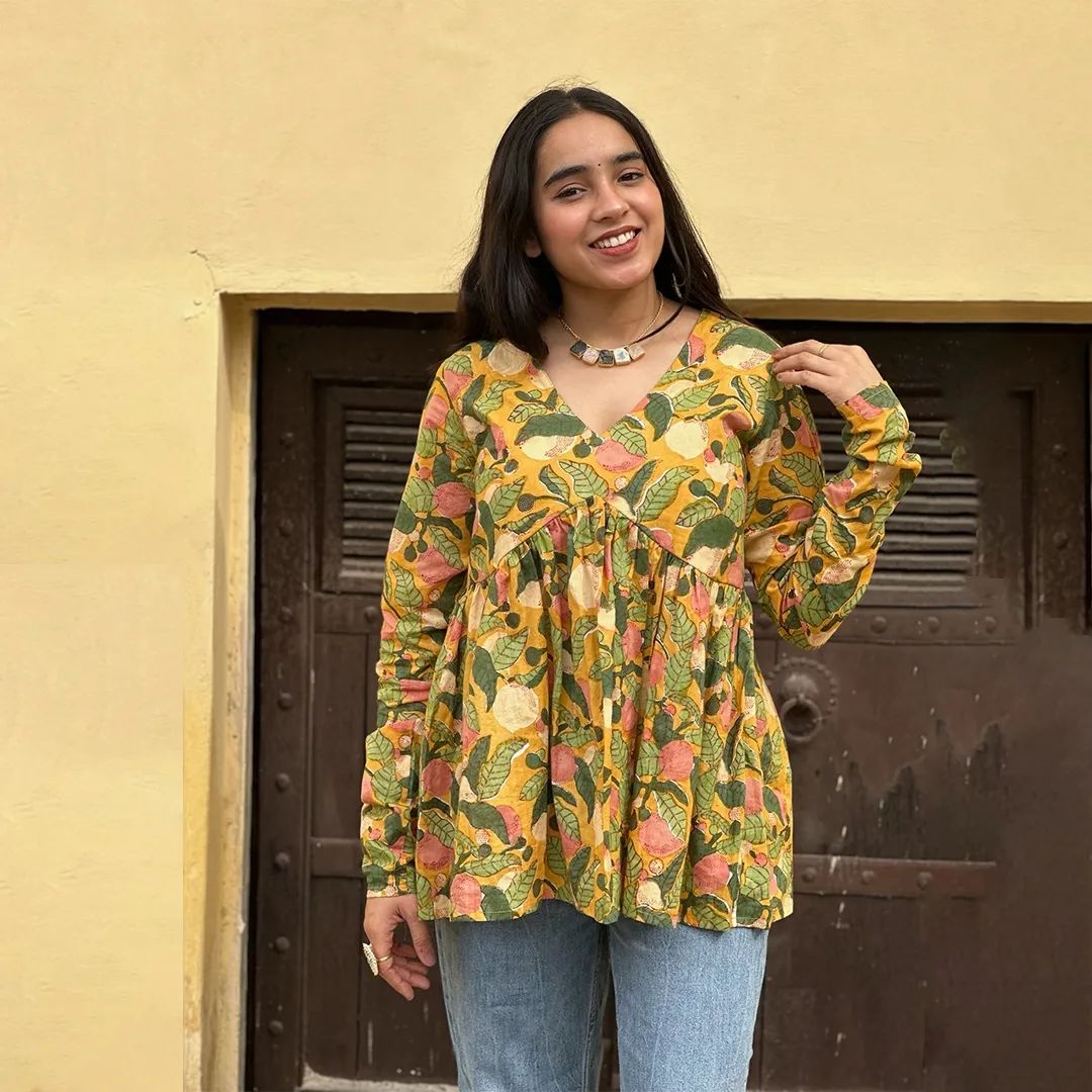 A woman wearing a blue floral cotton kurti