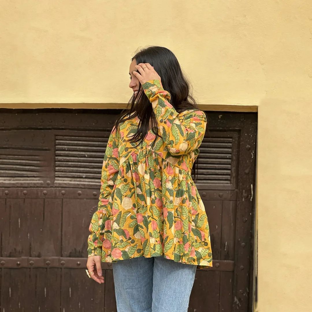 A woman wearing a blue floral cotton kurti