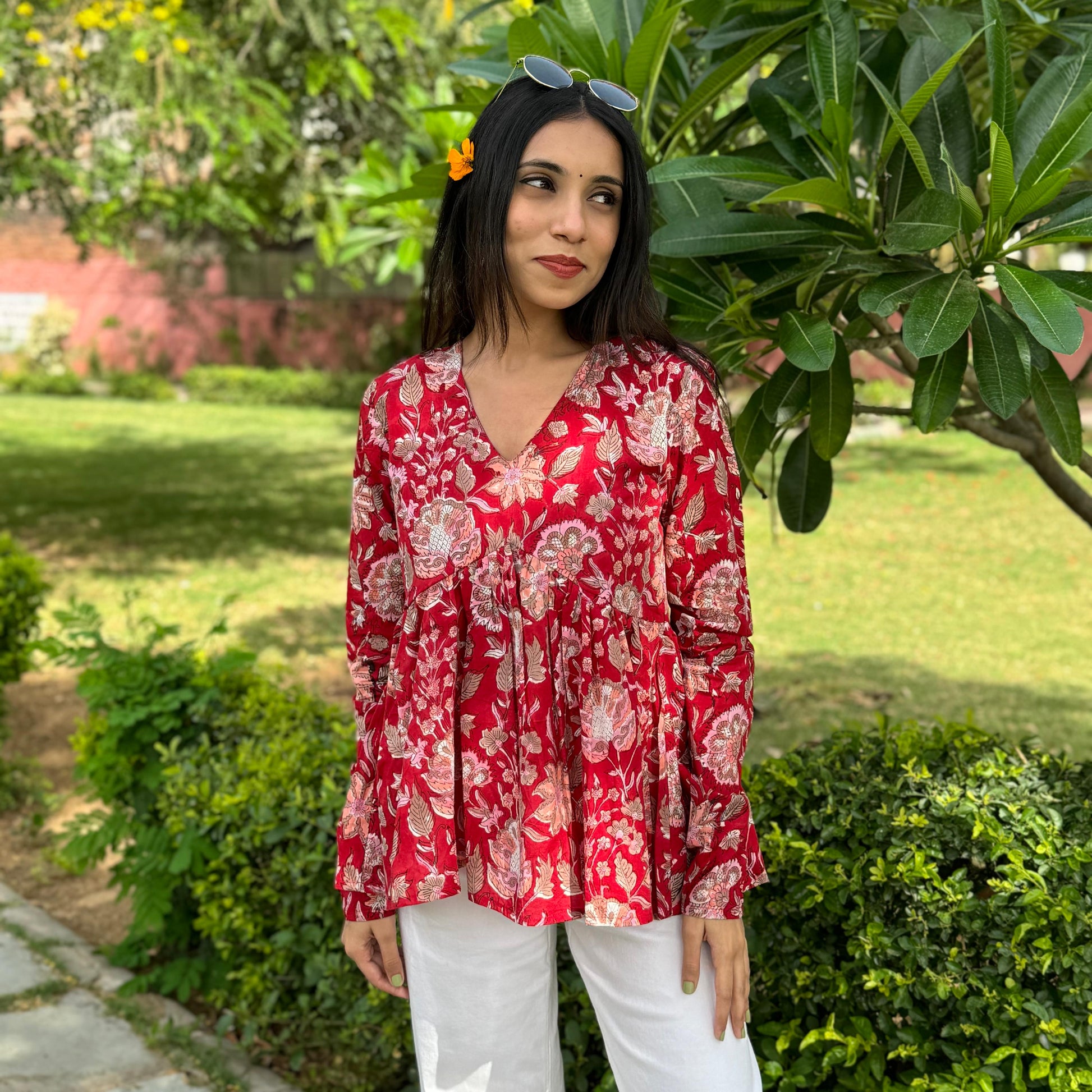 A woman wearing a blue floral cotton top