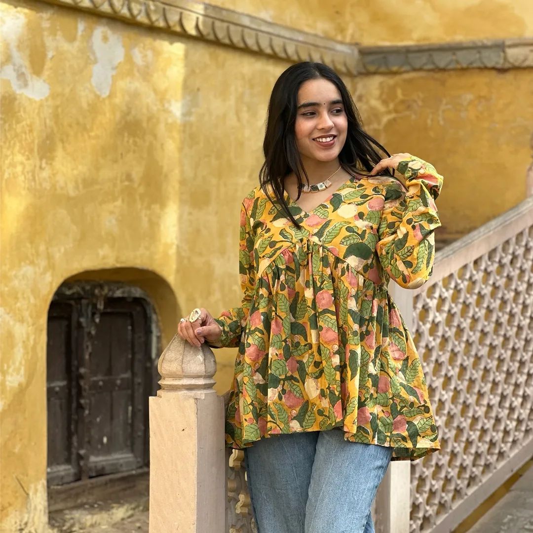A woman wearing a blue floral cotton kurti
