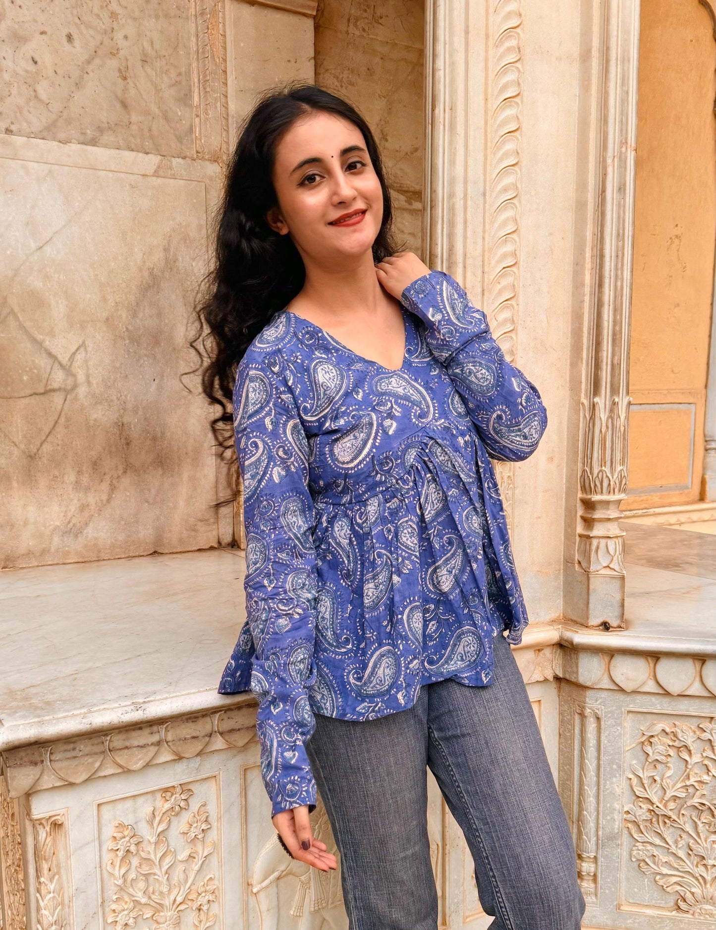A woman wearing a blue floral cotton top