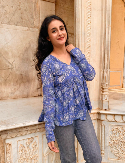 A woman wearing a blue floral cotton top