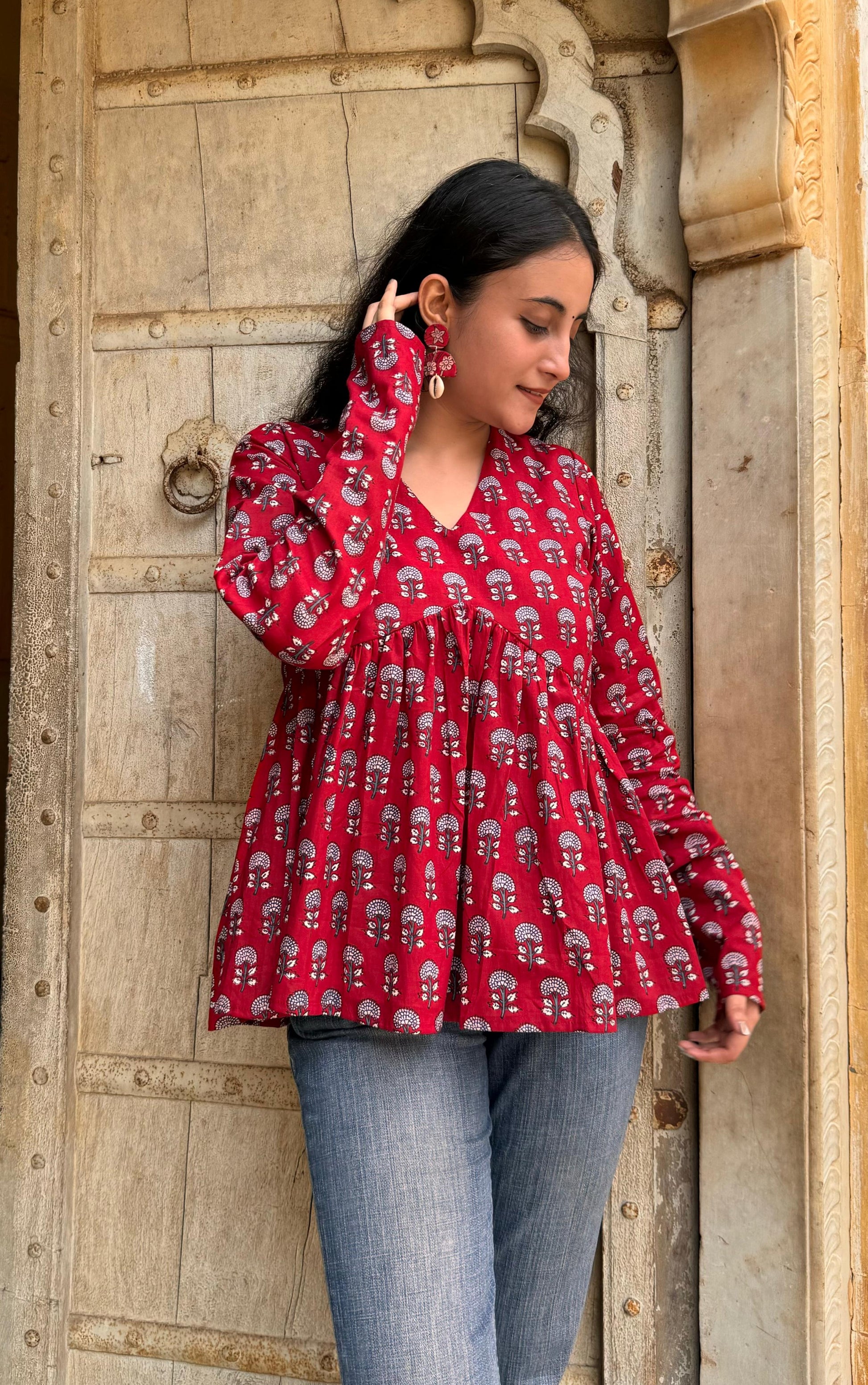 A woman wearing a Red Buti floral cotton top