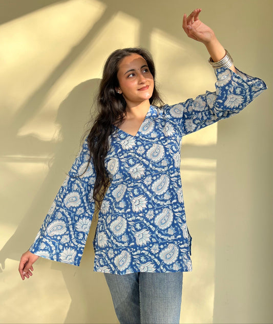 A woman wearing a blue floral cotton  kurti
