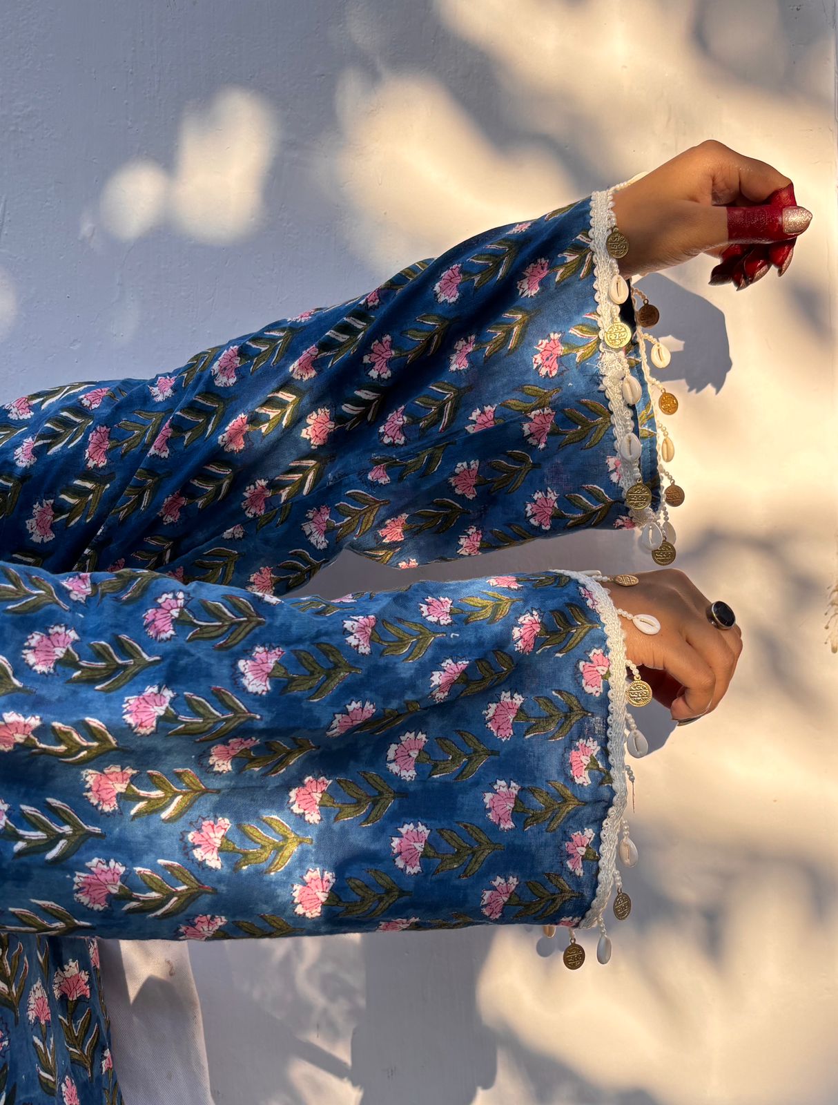 Blue floral embroidered outfit with a blurred background