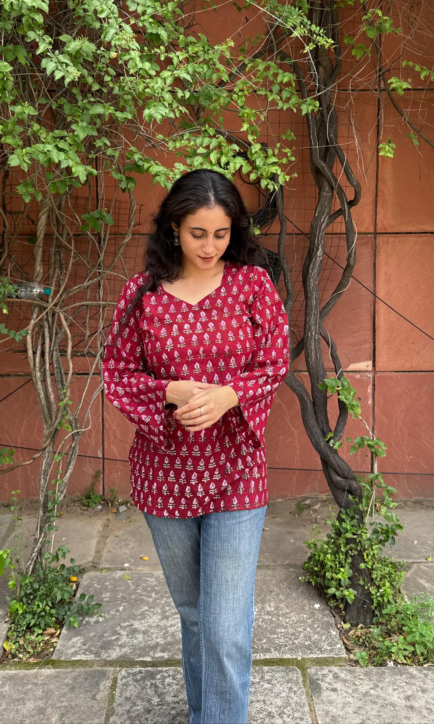 A woman wearing a blue floral cotton kurti
