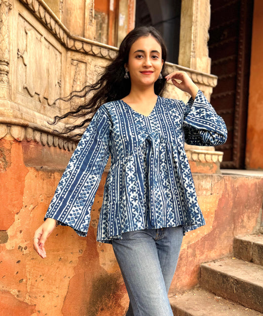 A woman wearing a blue floral cotton Top