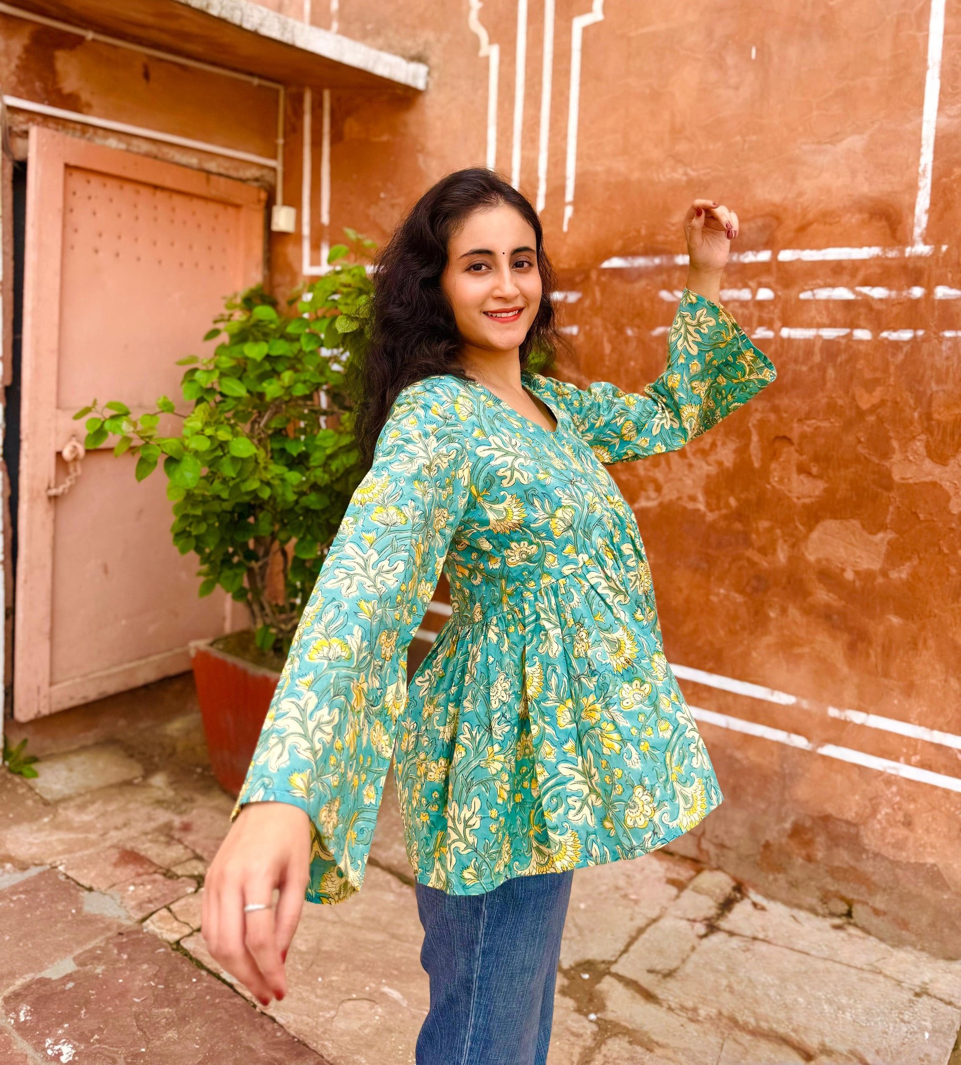 A woman wearing a blue floral cotton Top