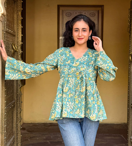 A woman wearing a blue floral cotton Top