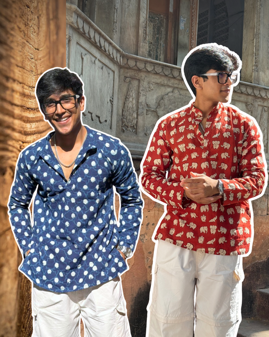 Two men wearing patterned shirts standing in front of a textured wall.