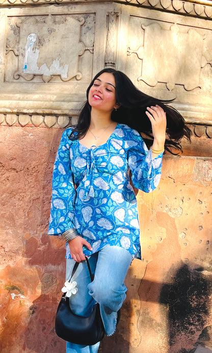  A woman wearing a  floral cotton kurti