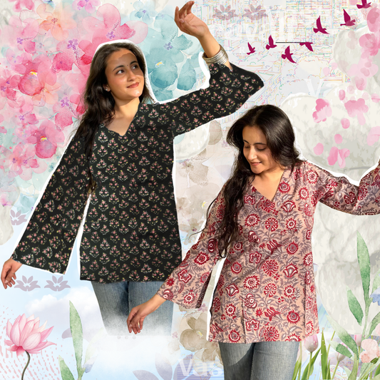 Two models wearing floral short kurtis, one in black and the other in pink, standing against a floral background.