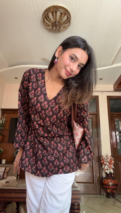 A woman wearing a blue floral cotton kurti