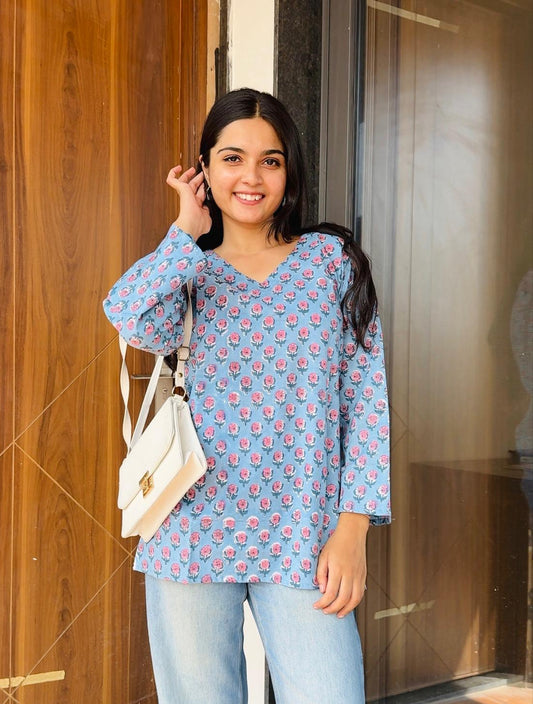 A woman wearing a blue floral cotton kurti