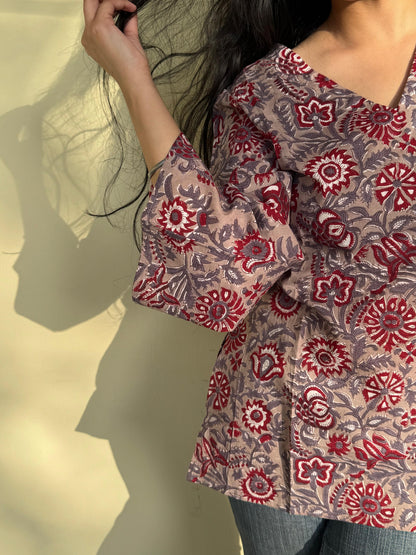 A woman wearing a blue floral cotton kurti