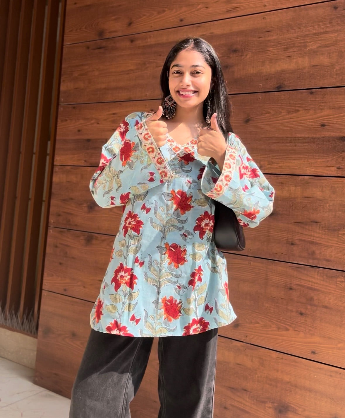 A woman wearing a blue floral cotton kurti
