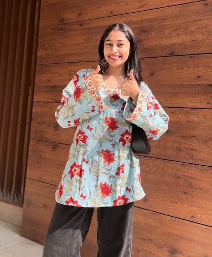 A woman wearing a blue floral cotton kurti