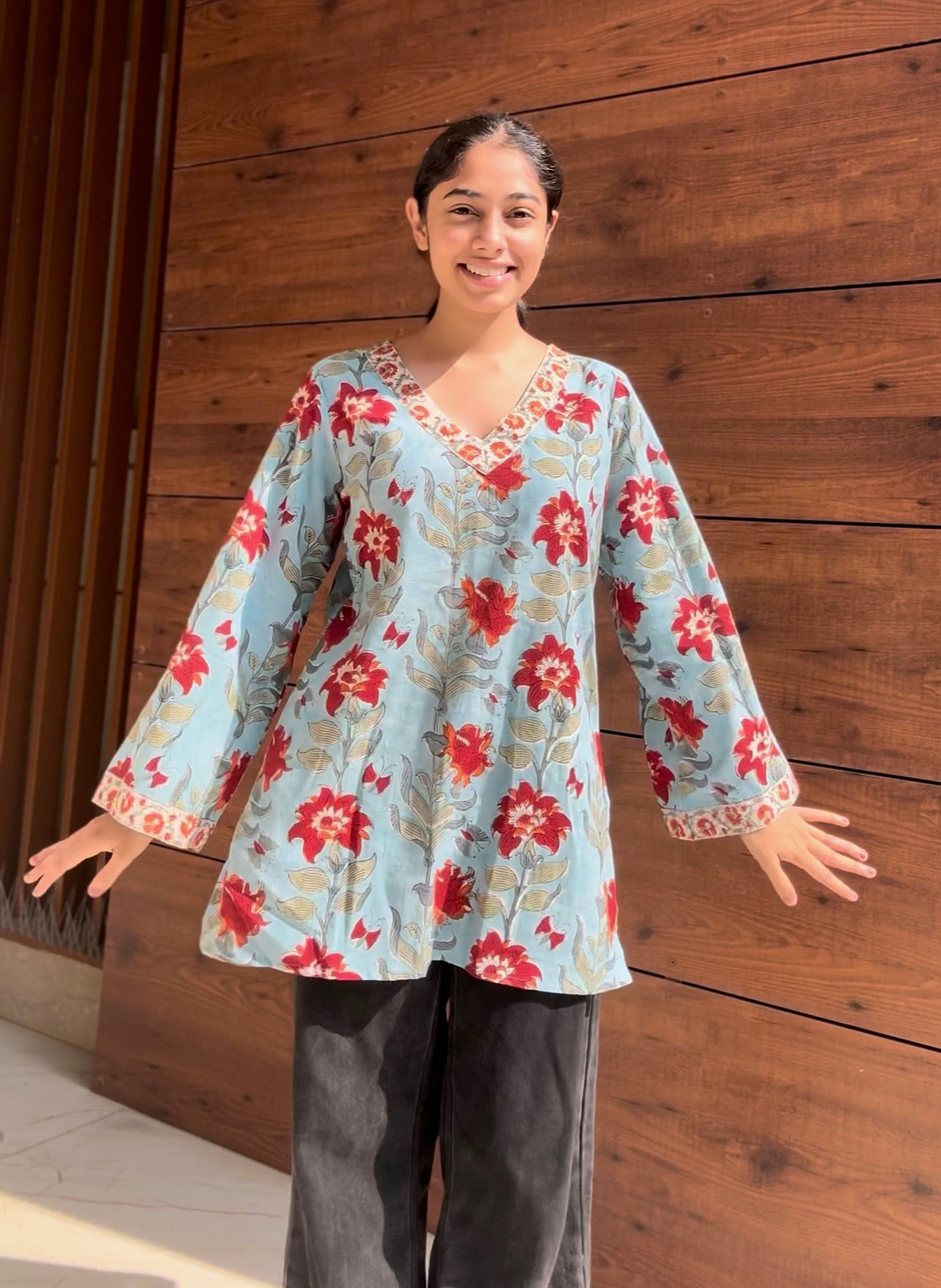 A woman wearing a blue floral cotton kurti