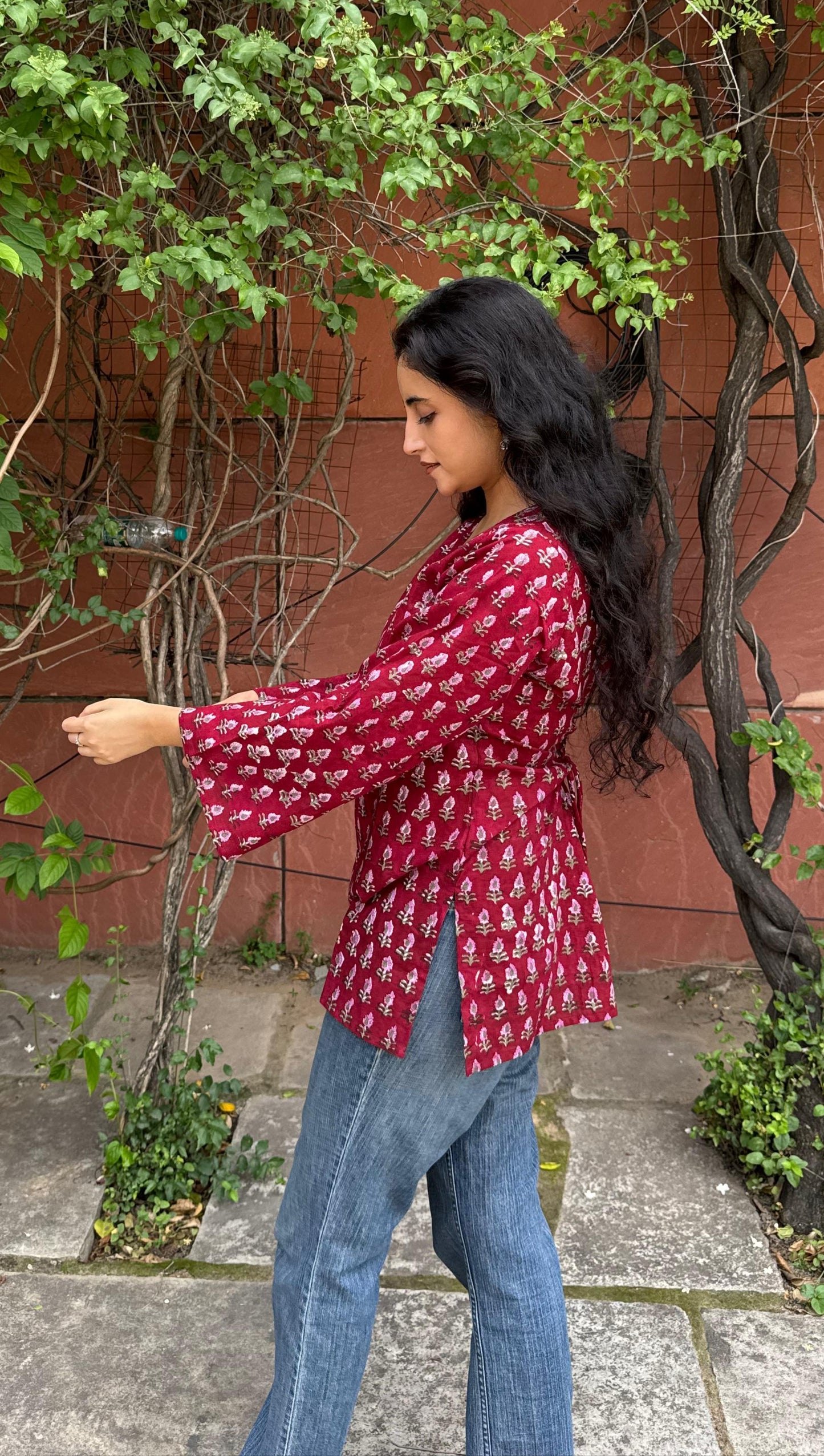 A woman wearing a blue floral cotton kurti