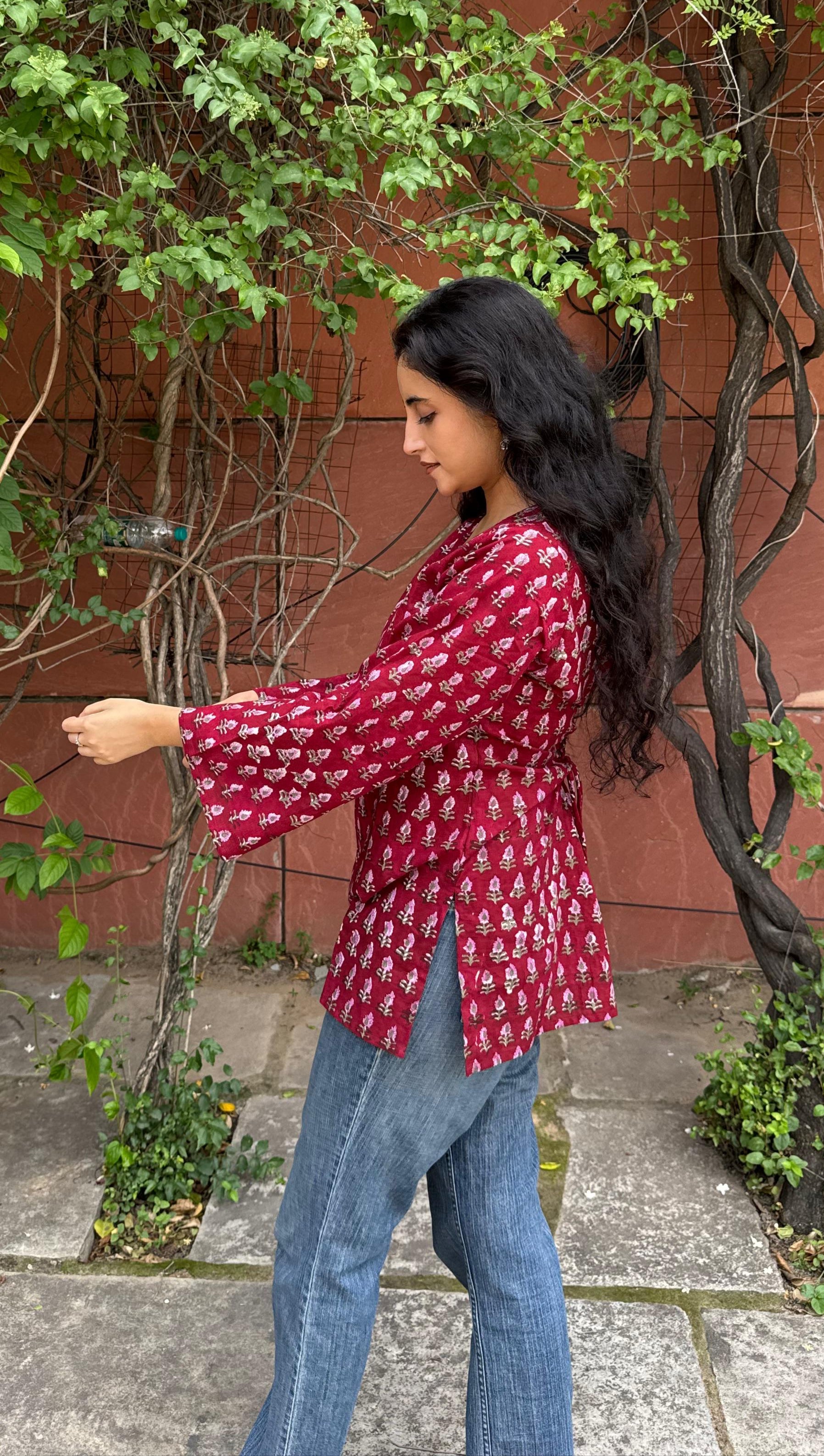 A woman wearing a blue floral cotton kurti