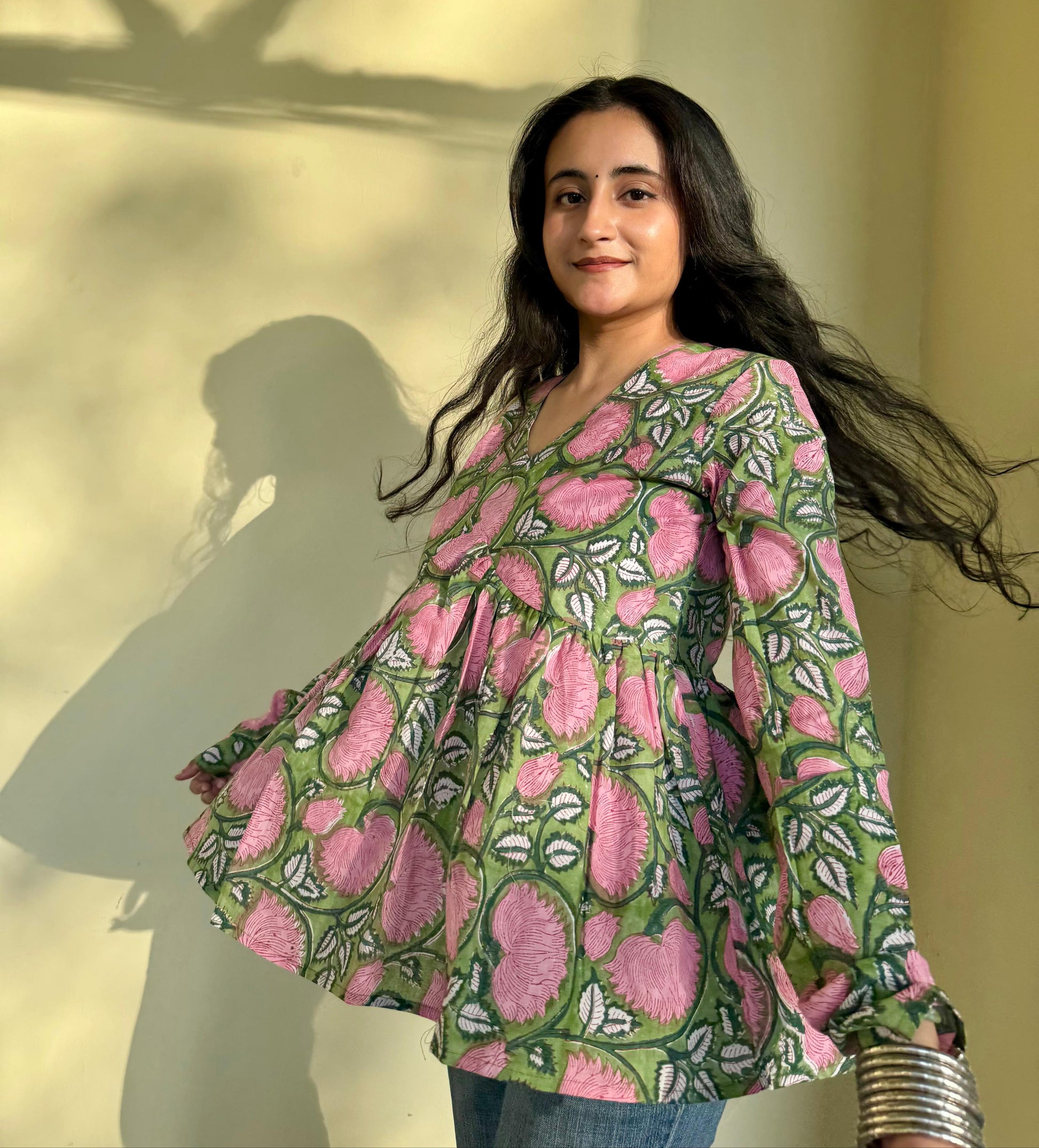 A woman wearing a blue floral cotton kurti