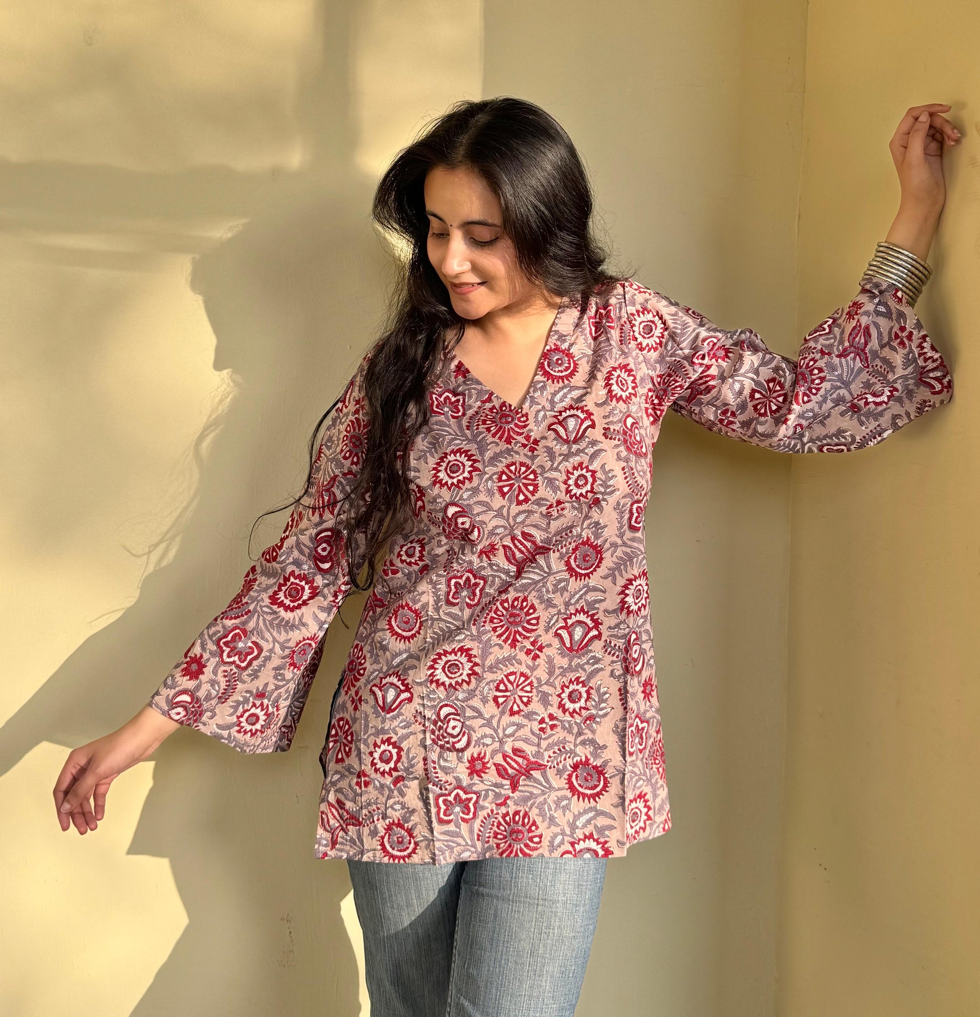 A woman wearing a floral cotton kurti